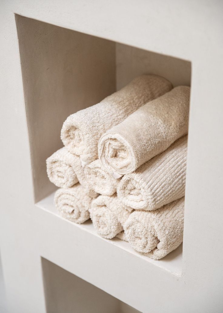 Fluffy white towels folded neatly after natural towel reset with soda crystals and laundry powder