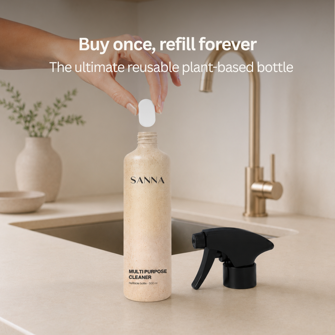 Natural multi-purpose cleaner refill tablet dissolving in reusable plant-based bottle
